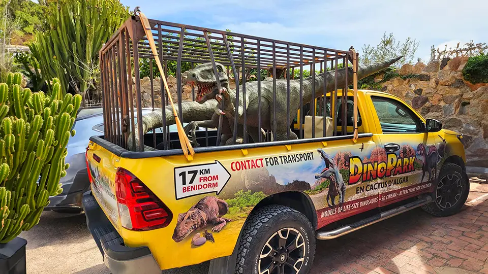 Dino Park Algar and the attractions. Car with cage dinosaur.